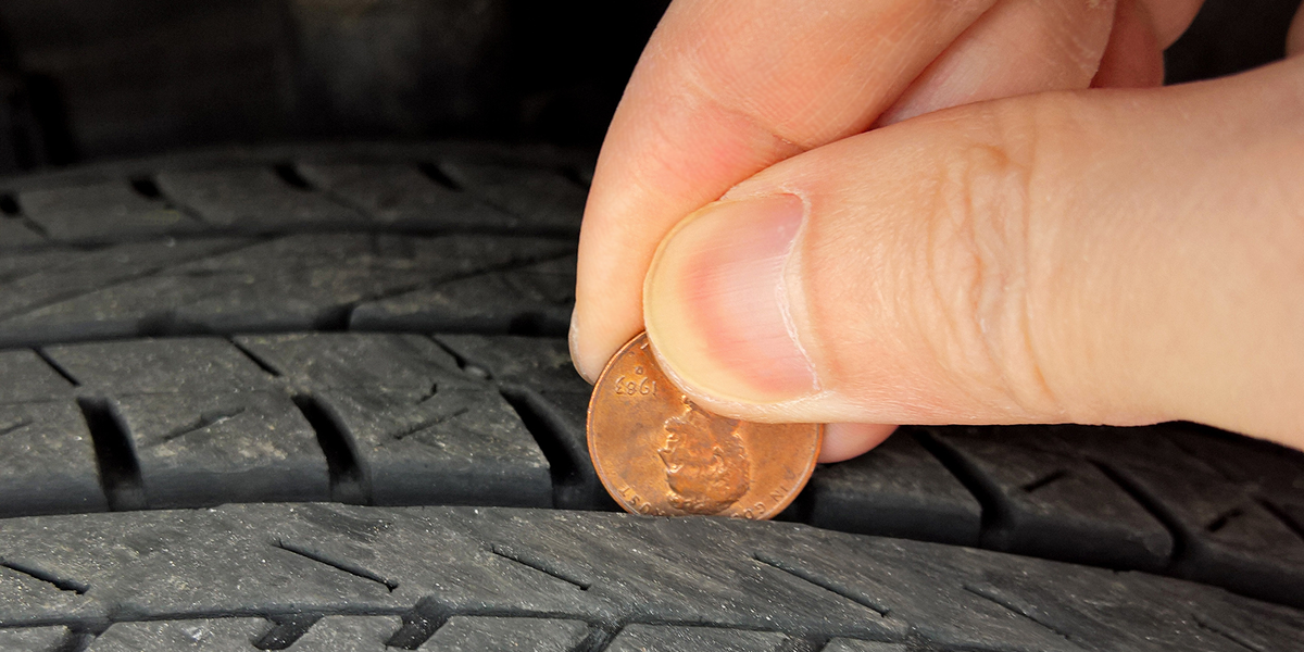 Side-by-side comparison of proper tire tread depth versus worn tires for winter driving safety
