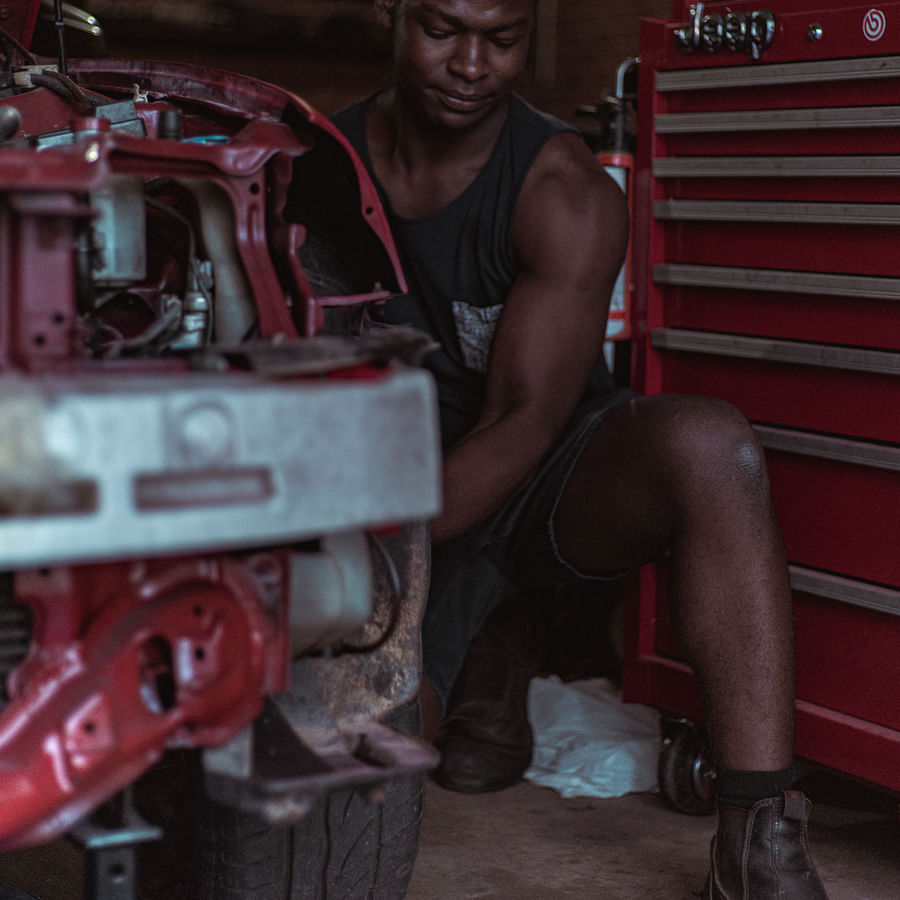 Professional mechanic examining a car in a garage