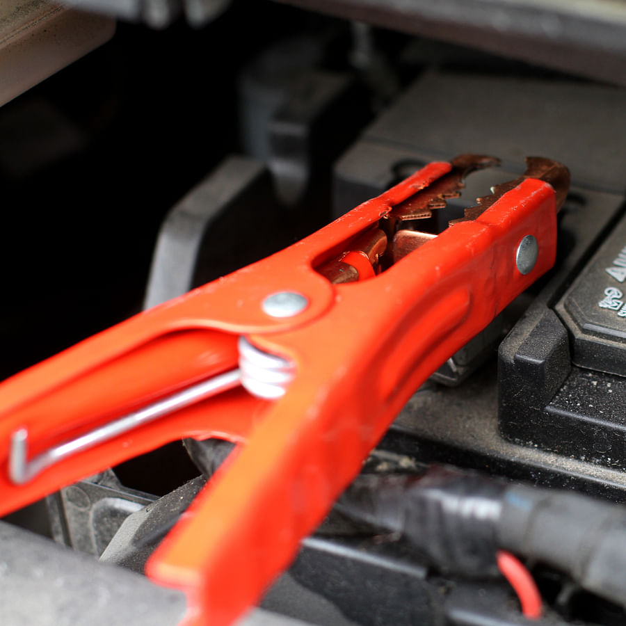 Car battery with jumper cables attached