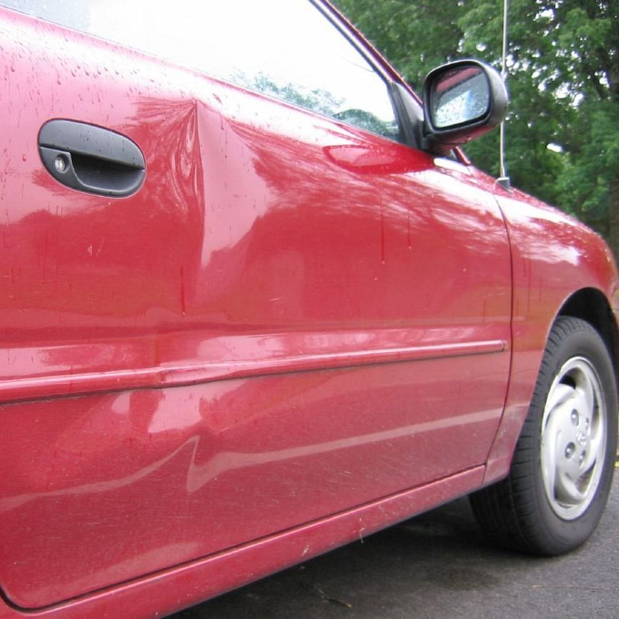 Car with various sizes of dents showcasing the need for dent repair