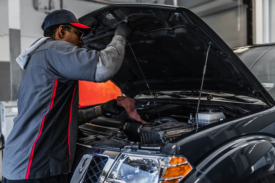 Mechanic expertly working on a Nissan car engine