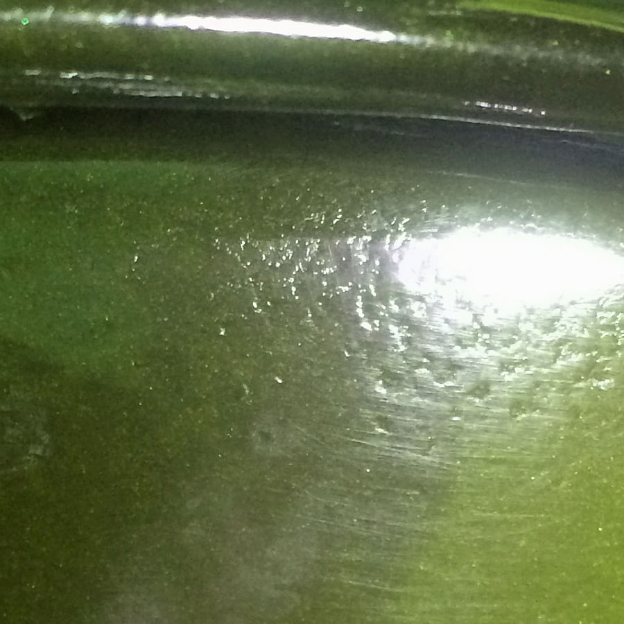 Close-up view of a car with deep scratches and paint chips