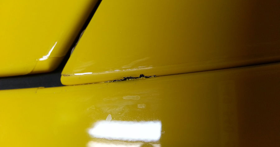 Close-up view of a car with paint scratches and chips